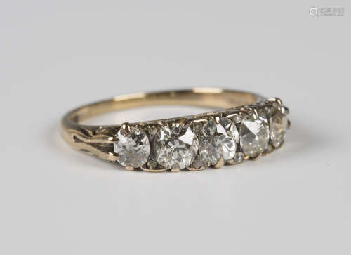 A gold and diamond five stone ring, claw set with a row of circular cut diamonds graduating to the