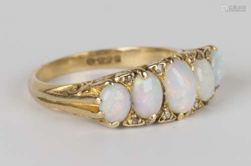 An 18ct gold, opal and diamond ring, mounted with a row of five graduated oval opals with rose cut