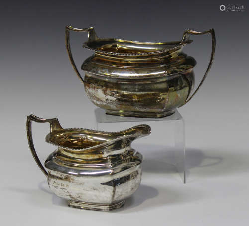 A George V silver two-handled sugar bowl and milk jug, each of rectangular cushion form with