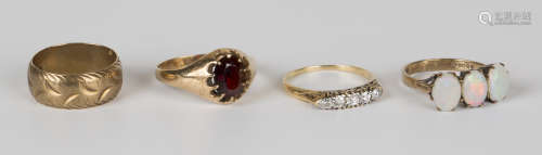 A gold and diamond five stone ring, mounted with a row of cushion shaped diamonds, decorated with