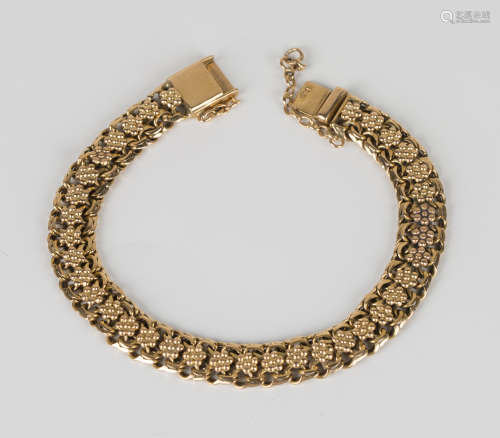 A gold bracelet in a floral and multi-link design, on a snap clasp, bearing Portuguese hallmarks