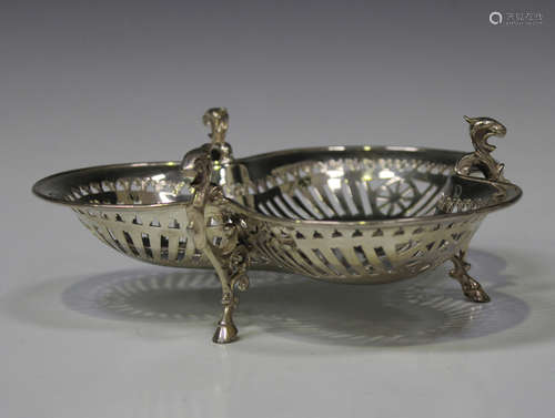 A late Victorian silver trefoil shaped dish with pierced sides, raised on three scroll legs,