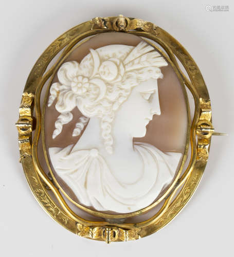 A Victorian gold mounted oval shell cameo brooch, carved as a portrait of a classical lady, the