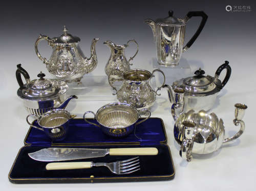 A small group of plated items, including a three-piece tea set of half-reeded form, another three-