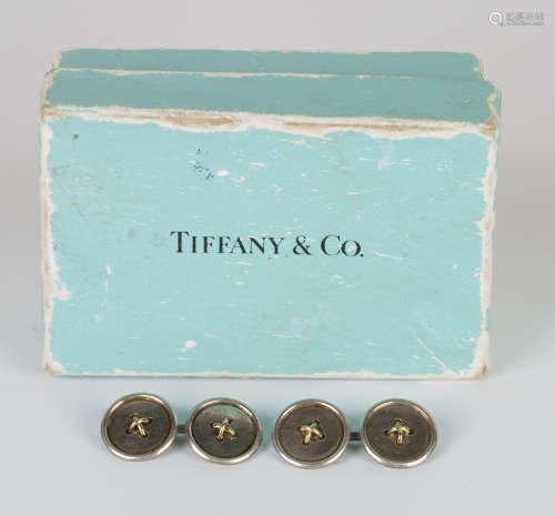 A pair of Tiffany & Co .925 silver and gold cufflinks, each in the form of two buttons with a gold