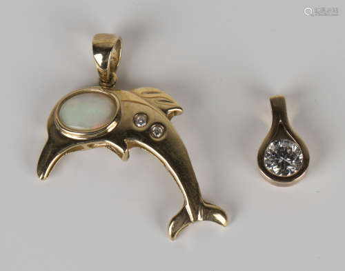 A 9ct gold, opal and diamond pendant in the form of a leaping dolphin, length 2.6cm, and a gold