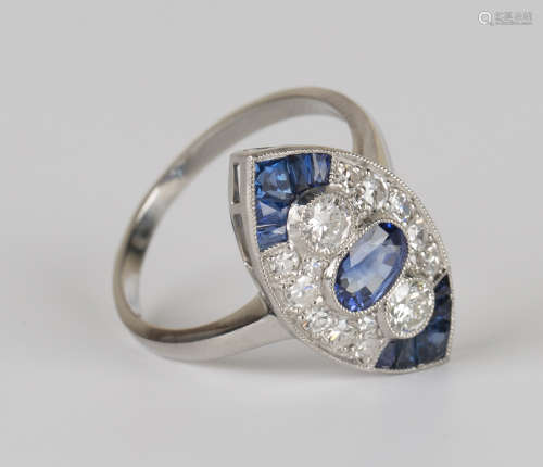 A platinum, sapphire and diamond marquise shaped ring, collet set with the principal oval cut