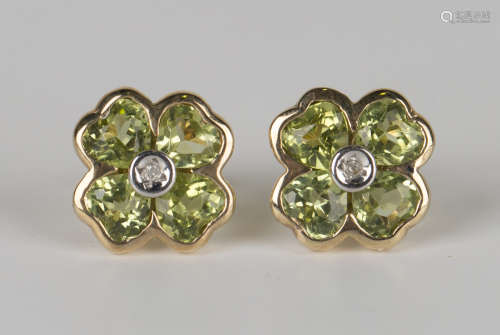 A pair of gold, peridot and diamond earstuds, each in the form of a flower, with post and