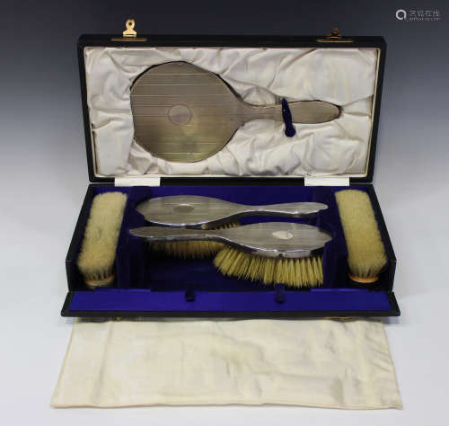 A George V silver five-piece dressing table set with engine turned decoration, comprising hand