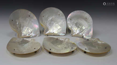 A set of six Elizabeth II mother-of-pearl shell dishes, each with silver gilt ball feet, Sheffield