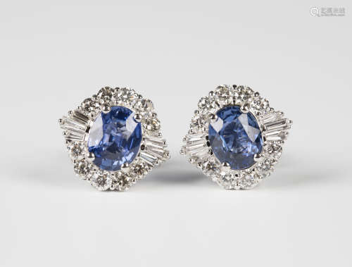 A pair of 18ct white gold, sapphire and diamond cluster earrings, each claw set with an oval cut