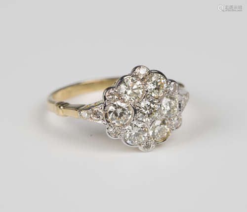 A gold and diamond cluster ring, mounted with the seven principal circular cut diamonds within six