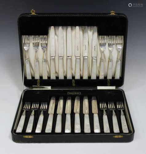 A set of twelve George V silver dessert knives and forks with mother-of-pearl handles, Sheffield