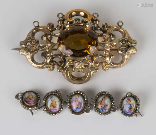 A Victorian gold and citrine single stone brooch, pierced in a scrolling shaped oval design, mounted