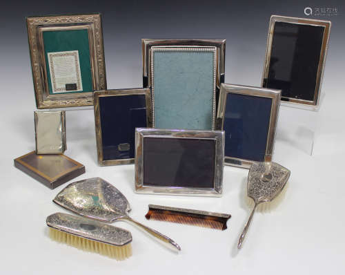 An Elizabeth II silver four-piece dressing table set, comprising hand mirror, clothes brush, hand