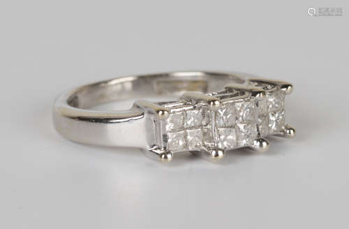 An 18ct white gold and diamond ring, designed as three four stone square clusters, mounted with
