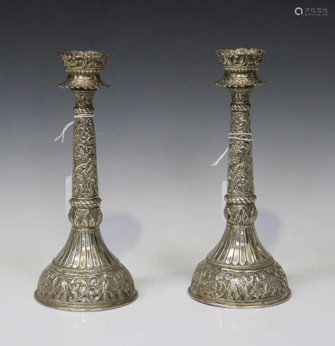 A pair of 20th century .800 silver candlesticks, probably Indian, of tapering form, decorated in