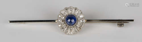 A cabochon sapphire and diamond bar brooch in the form of a flowerhead shaped cluster, mounted