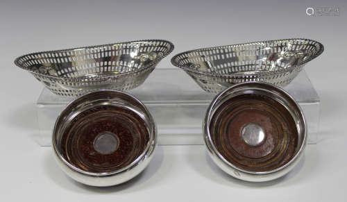 A pair of Edwardian silver oval bonbon dishes, each with a beaded rim above pierced and embossed