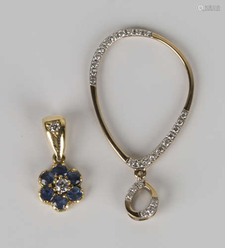 A gold and diamond pendant of oval hoop form with diamond set sections and a similar suspension