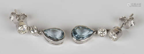 A pair of white gold, aquamarine and diamond pendant earrings, each collet set with a pear shaped