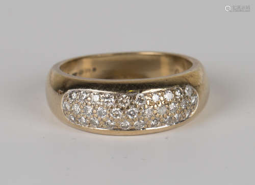 A 9ct gold and diamond ring in a bombé design, mounted with circular cut diamonds, detailed '.39',