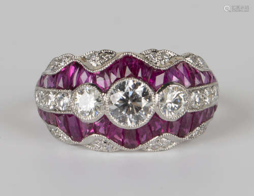 A platinum, ruby and diamond ring, collet set with three principal circular cut diamonds between