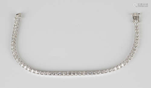 A white gold and diamond bracelet, claw set with a row of circular cut diamonds, on a snap clasp,