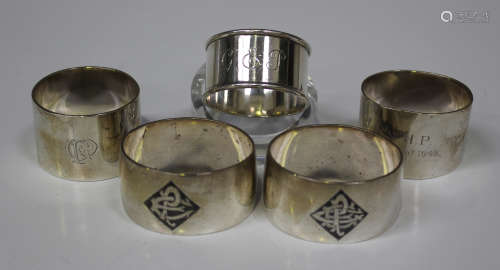 Three silver napkin rings, including a cylindrical example, Birmingham 1930 by Walker & Hall,