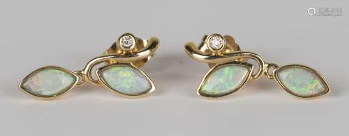 A pair of gold, opal and diamond pendant earrings, each in a foliate design, mounted with two