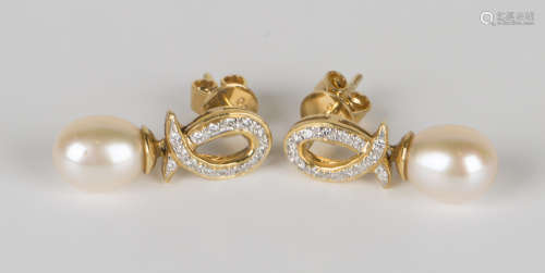 A pair of 18ct gold, diamond and cultured pearl earrings, each in a diamond set loop shaped design