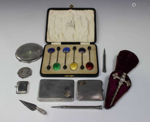 A set of six George V silver and enamelled bean end coffee spoons, each bowl back enamelled in a