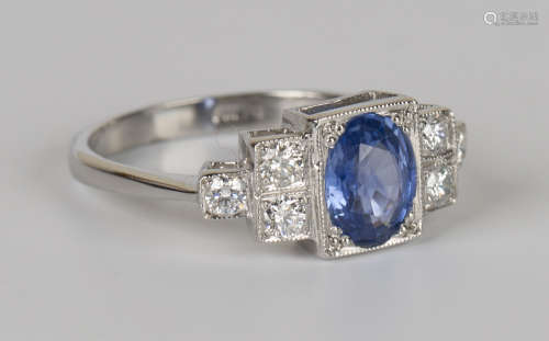 A platinum, sapphire and diamond ring, mounted with an oval cut sapphire in a square setting between