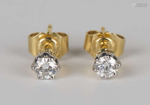 A pair of gold and diamond single stone earstuds, each claw set with a circular cut diamond, with