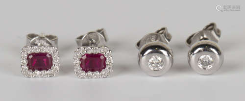 A pair of 18ct white gold, ruby and diamond earstuds, each mounted with a rectangular cut ruby