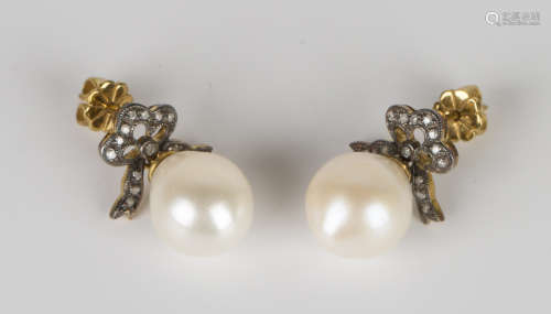 A pair of gold, silver, cultured pearl and diamond pendant earrings with ribbon bow surmounts,