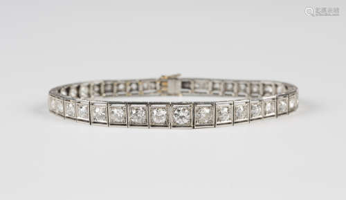 A platinum and diamond bracelet, mounted with a row of graduating circular cut diamonds, each in a