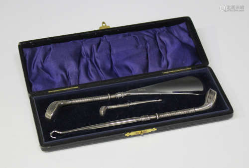An Edwardian silver handled shoehorn in the form of a golf club, together with matching shoe and
