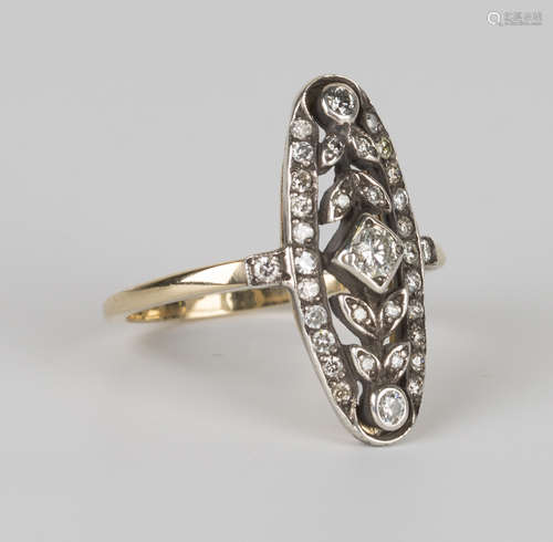 A diamond ring of oval openwork form, mounted with the principal circular cut diamond between