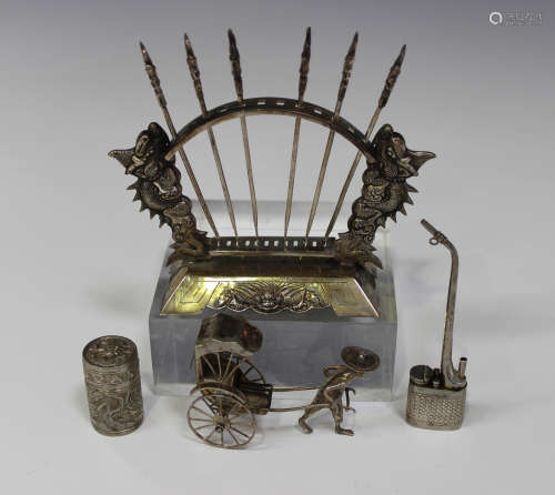 A Chinese silver toothpick stand with dragon supports, fitted with six toothpicks, height 11.2cm (