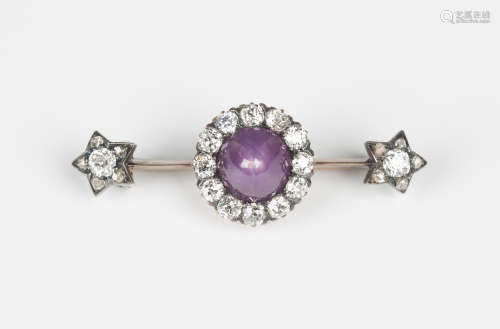A gold, diamond and star ruby cluster bar brooch, mounted with the cabochon star ruby within a