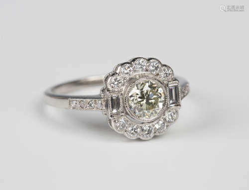 A platinum and diamond cluster ring, mounted with the principal circular cut diamond between two