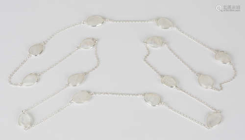 A silver and moonstone necklace, the oval link chain spaced with drop shaped moonstones, with a
