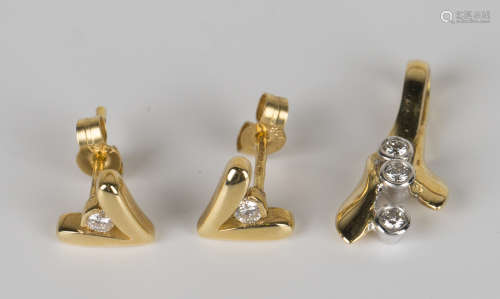 A pair of 18ct gold and diamond earrings, each in a 'V' shaped design centred by a circular cut