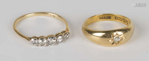 A gold and diamond five stone ring, mounted with a row of cushion shaped diamonds graduating in size