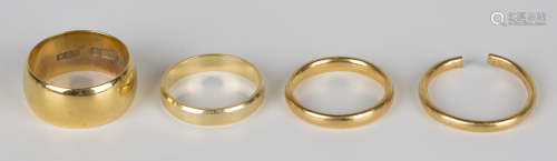 Two 22ct gold wedding rings (one cut), an 18ct gold wedding ring and a 9ct gold wide band wedding