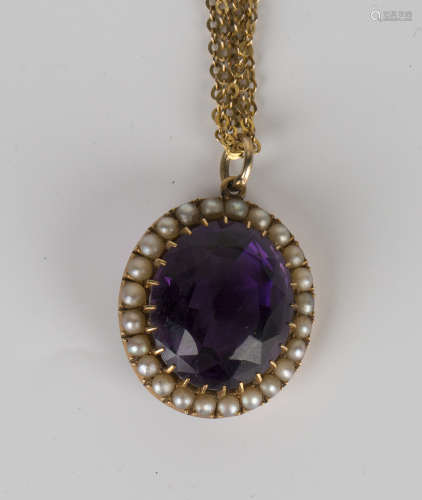 A gold, amethyst and half-pearl set oval pendant, circa 1910, claw set with the oval cut amethyst