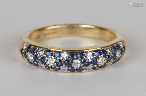An 18ct gold, sapphire and diamond ring, mounted with circular cut sapphires and diamonds in a