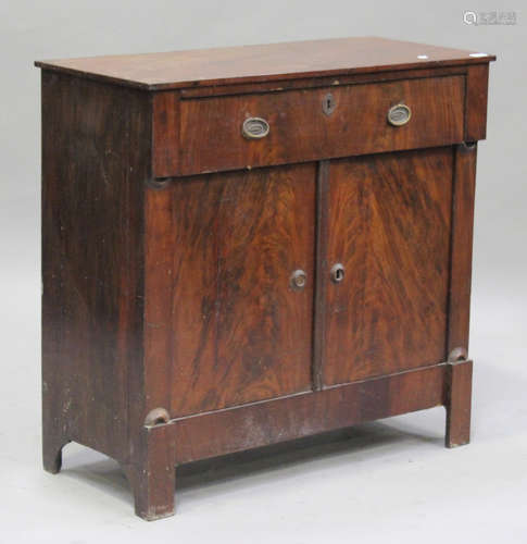 An early 19th century figured mahogany side cabinet, fitted with a single frieze drawer above a