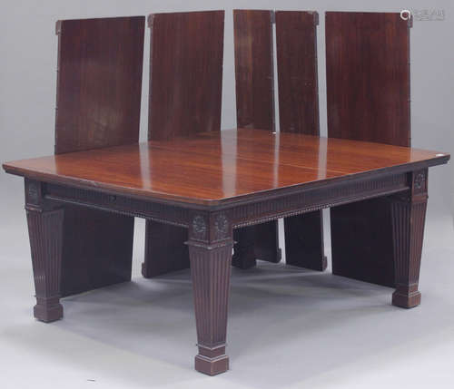 A large early 20th century Neoclassical Revival mahogany extending dining table, the moulded top